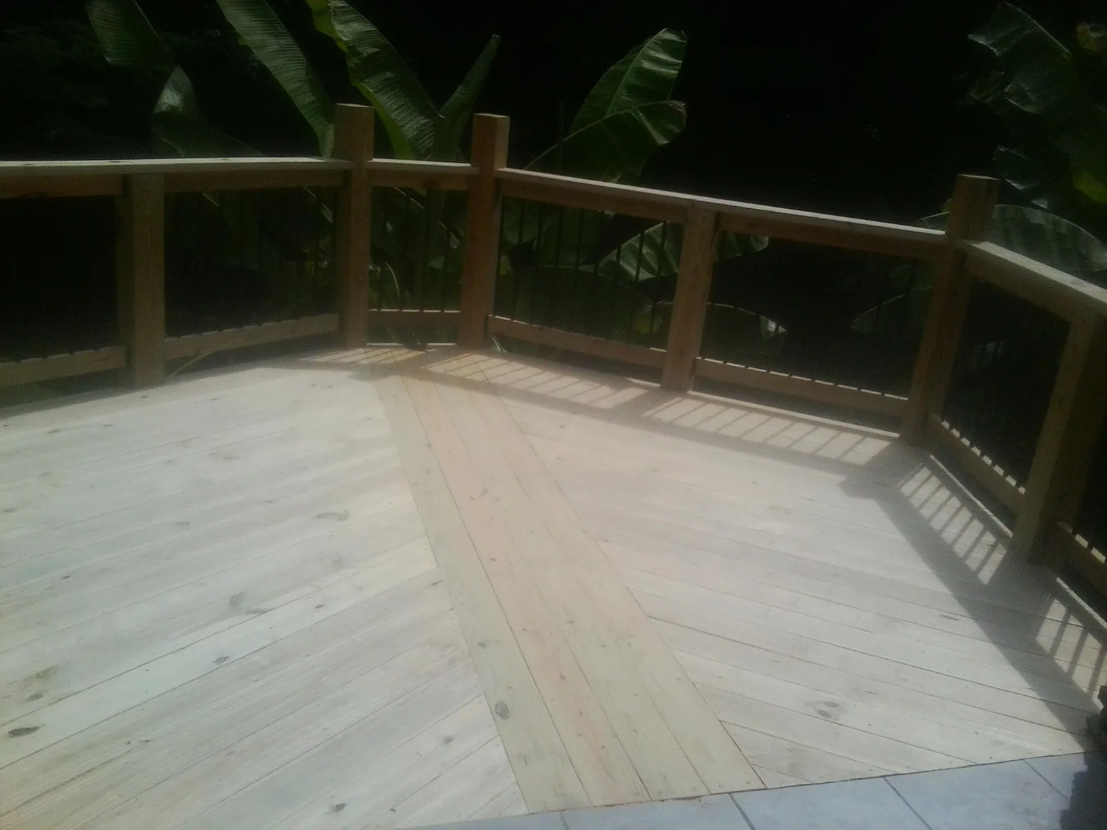 New wood deck and railing built off the back of a home in Vista